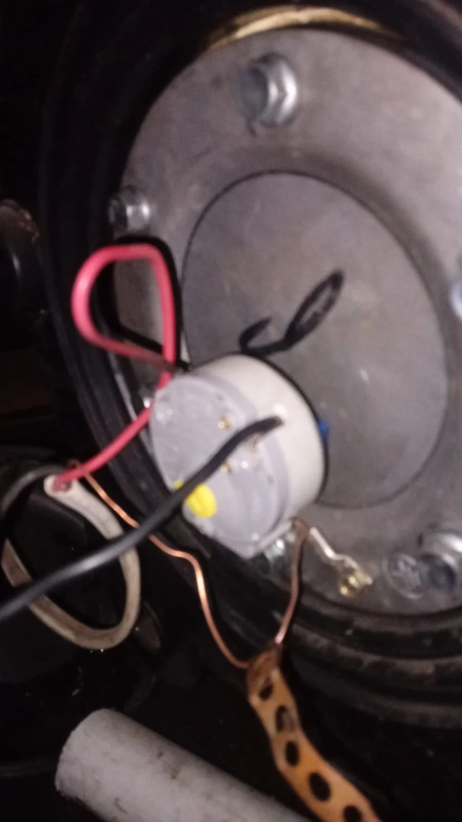 Geyser repair close-up showing thermostat and electrical component access during repair work.