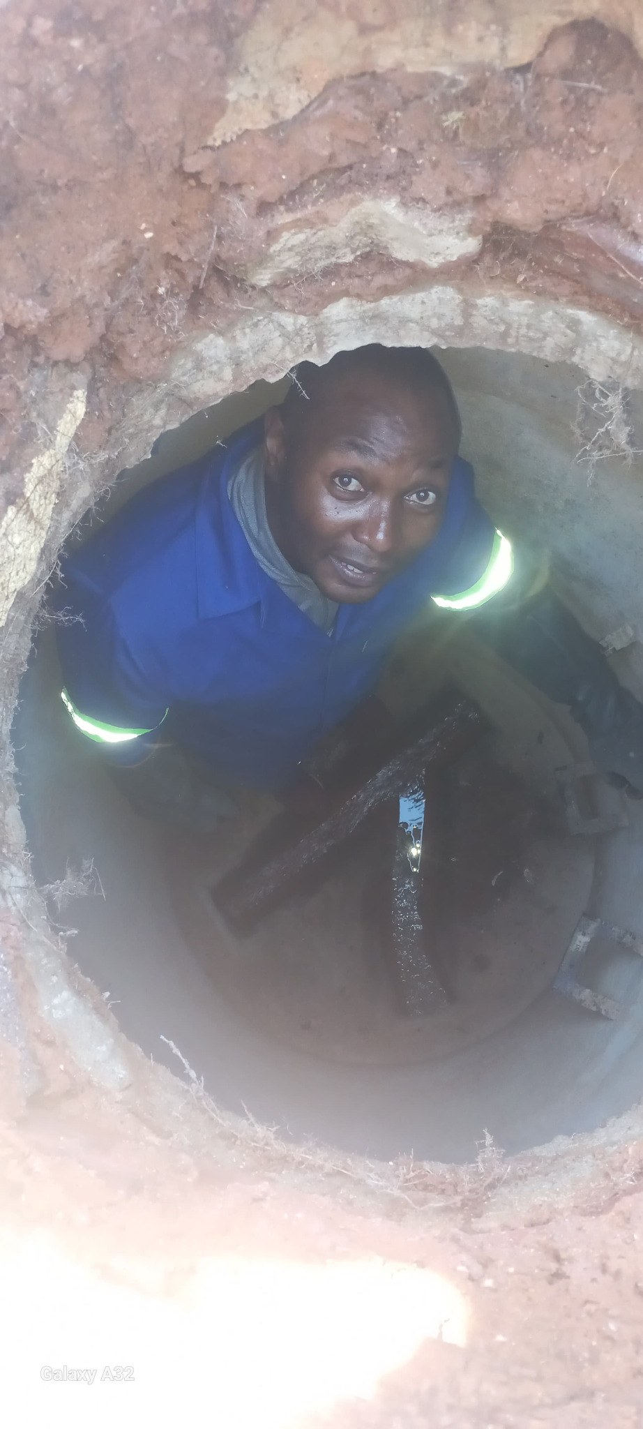 Stormwater drainage image showing a plumber inside a manhole or drainage chamber during inspection and maintenance by Plumb A Nator.